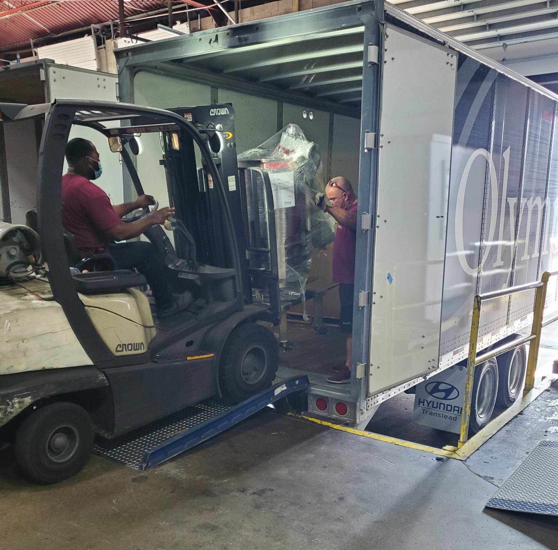 Warehouse staff inspecting and inventorying inbound shipments