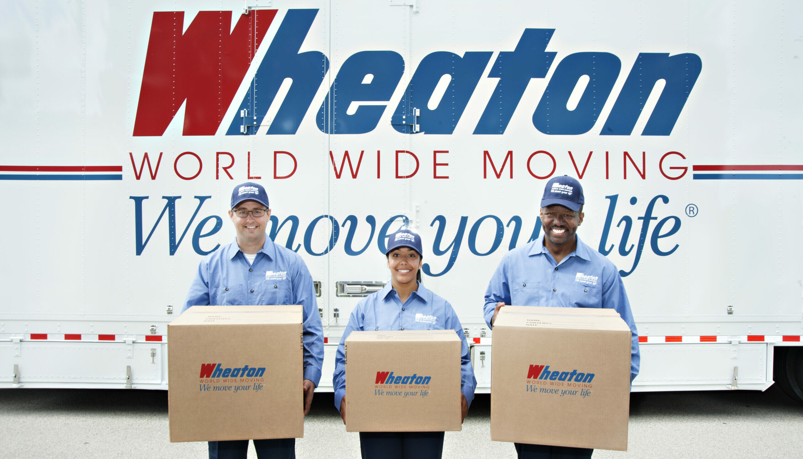 Wheaton World Wide Moving crew with boxes in front of a truck