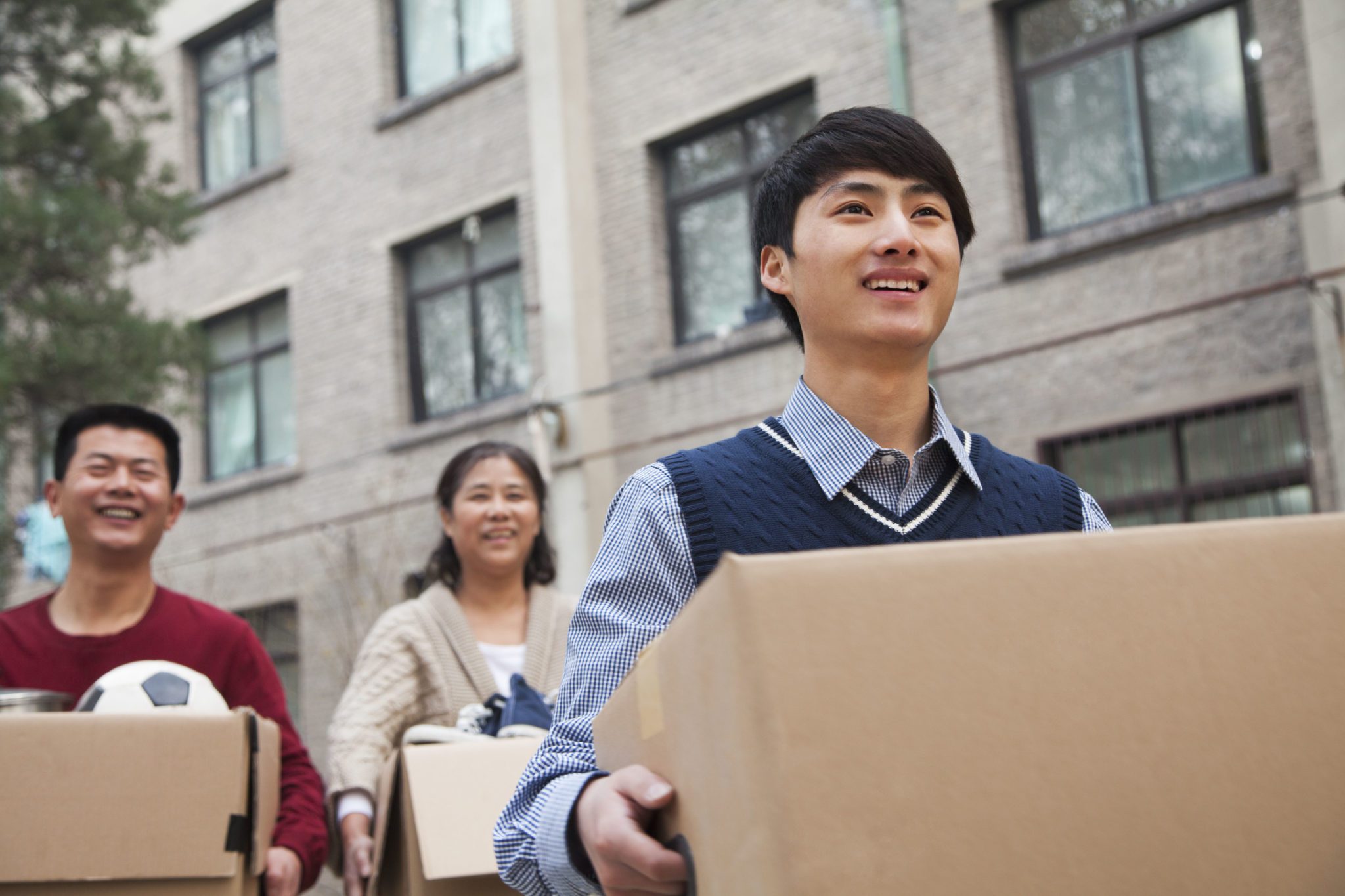 Movers helping a student move into a dorm room
