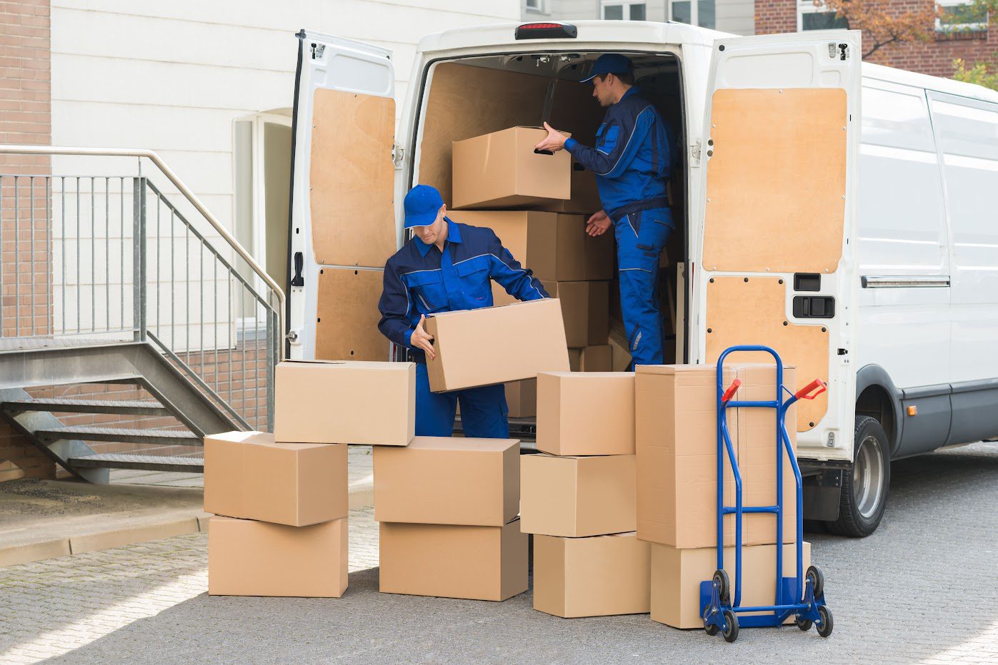 Movers placing furniture into a storage vault