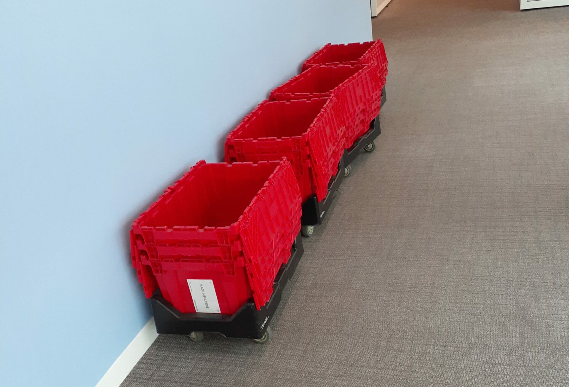 Color-coded labels applied to commercial moving crates