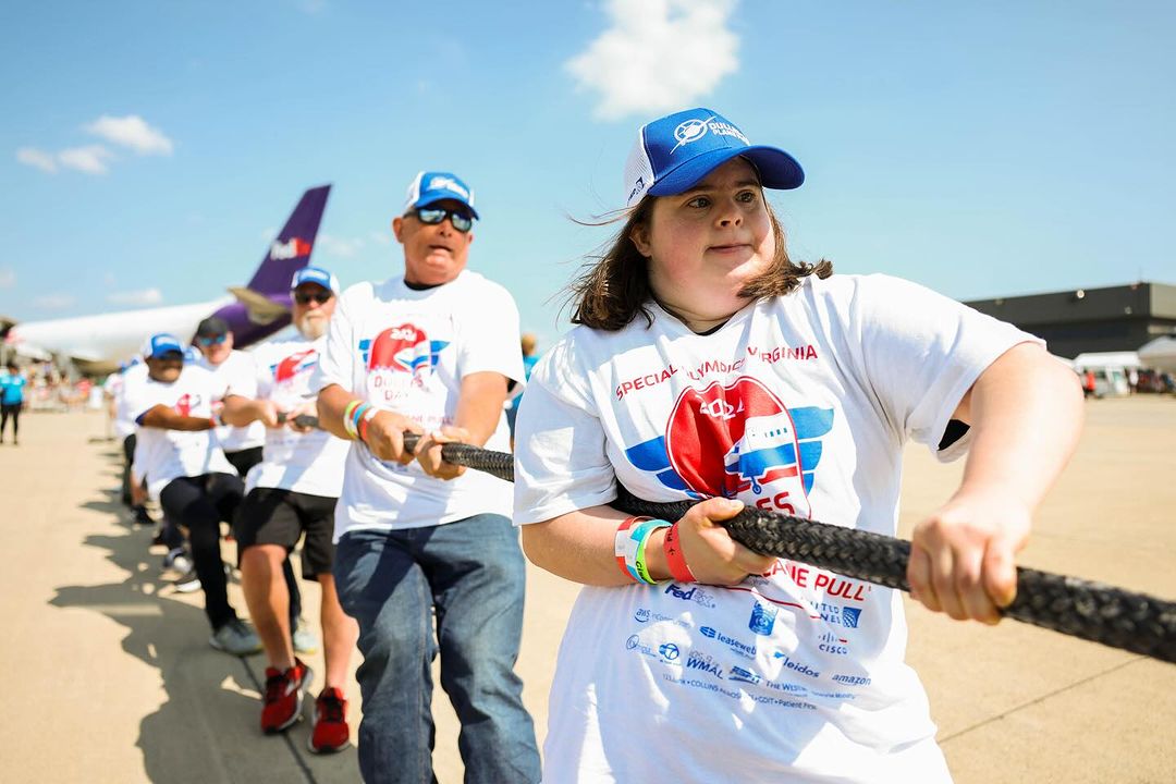 Olympia team pulling an airplane at the Special Olympics Plane Pull