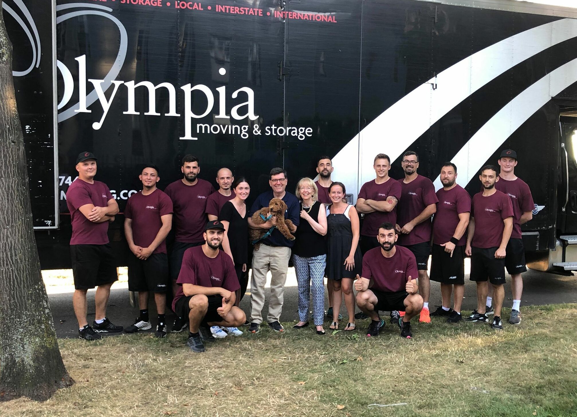Olympia crew loading sealed crates onto an interstate moving truck