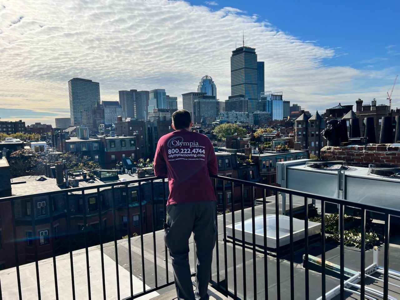 Olympia moving truck with the Boston skyline in the background
