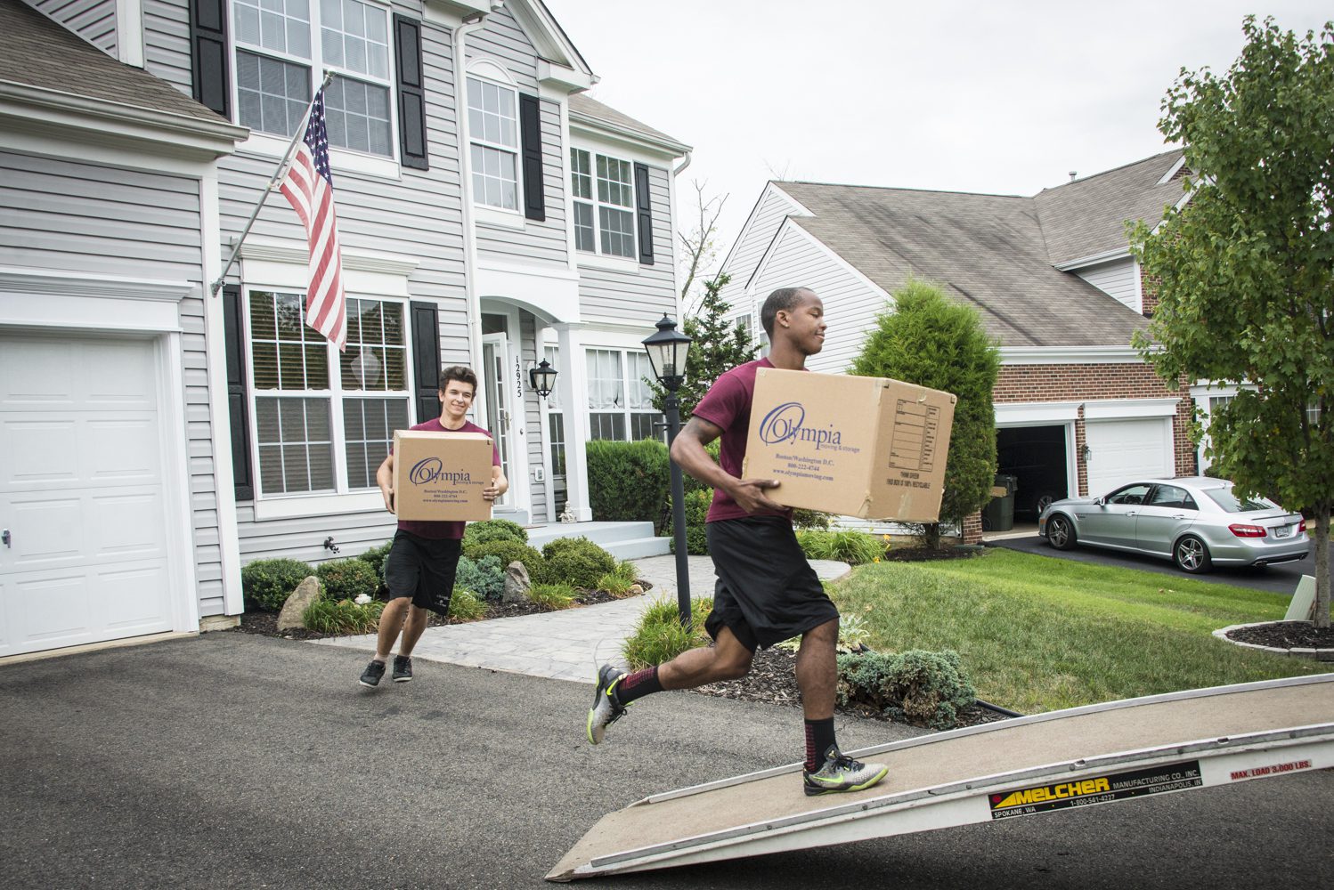 Olympia movers carrying furniture into a home during a local move