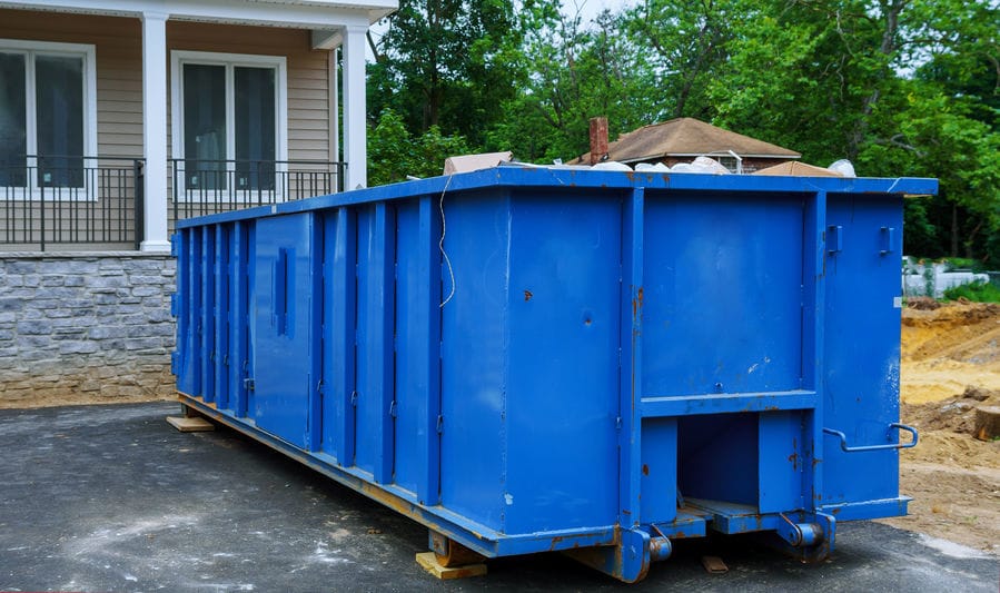 blue dumpster in driveway