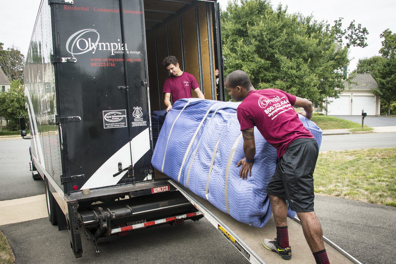 Olympia mover carrying boxes to a moving truck