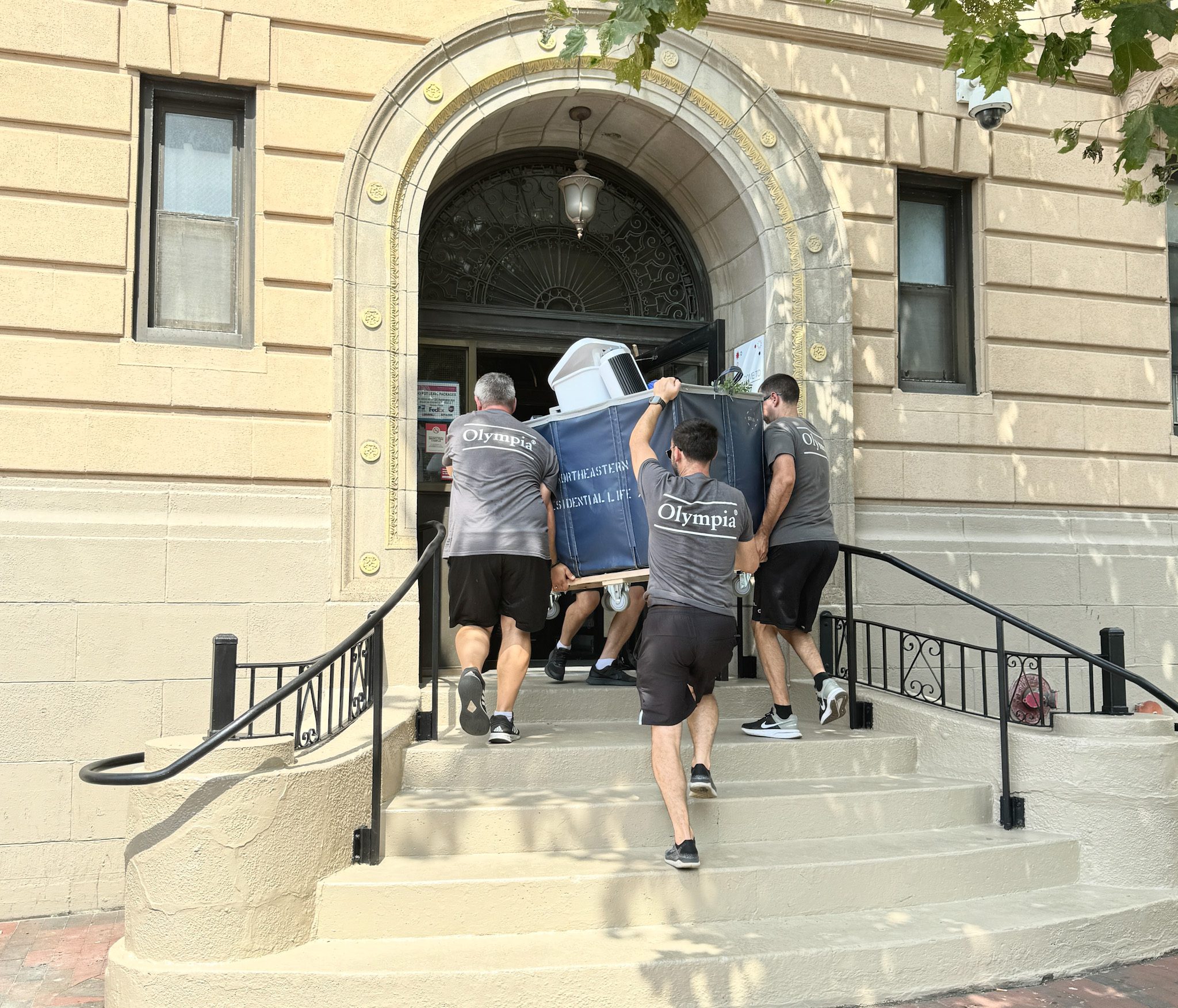 Olympia crew helping students move into a college dormitory