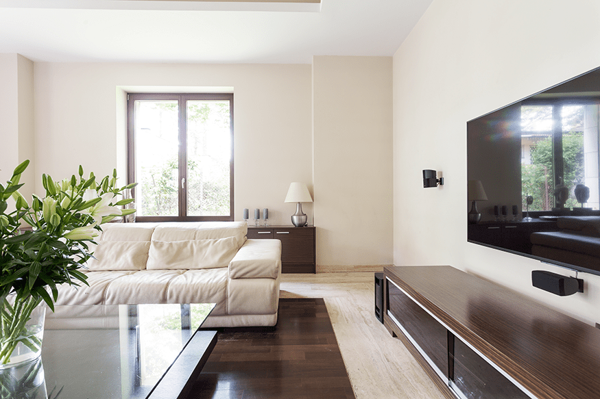 Technician mounting a television on a living room wall