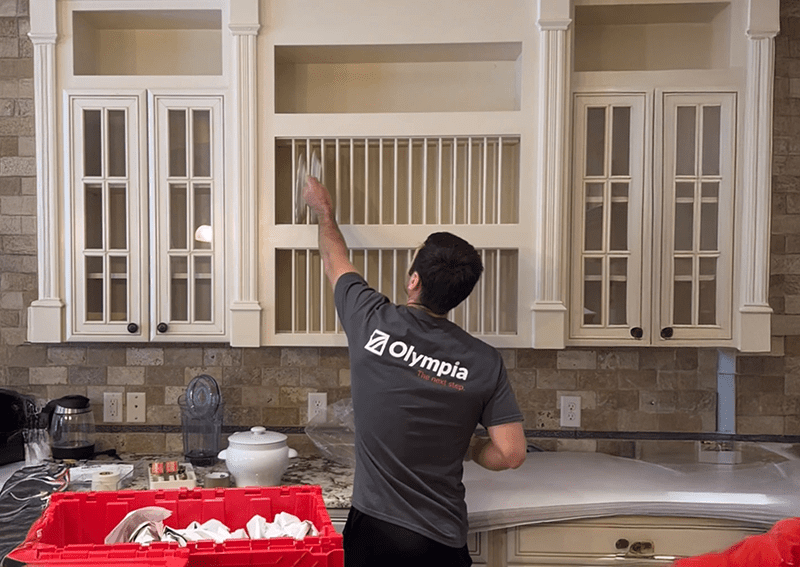 Technician mounting a television on a living room wall