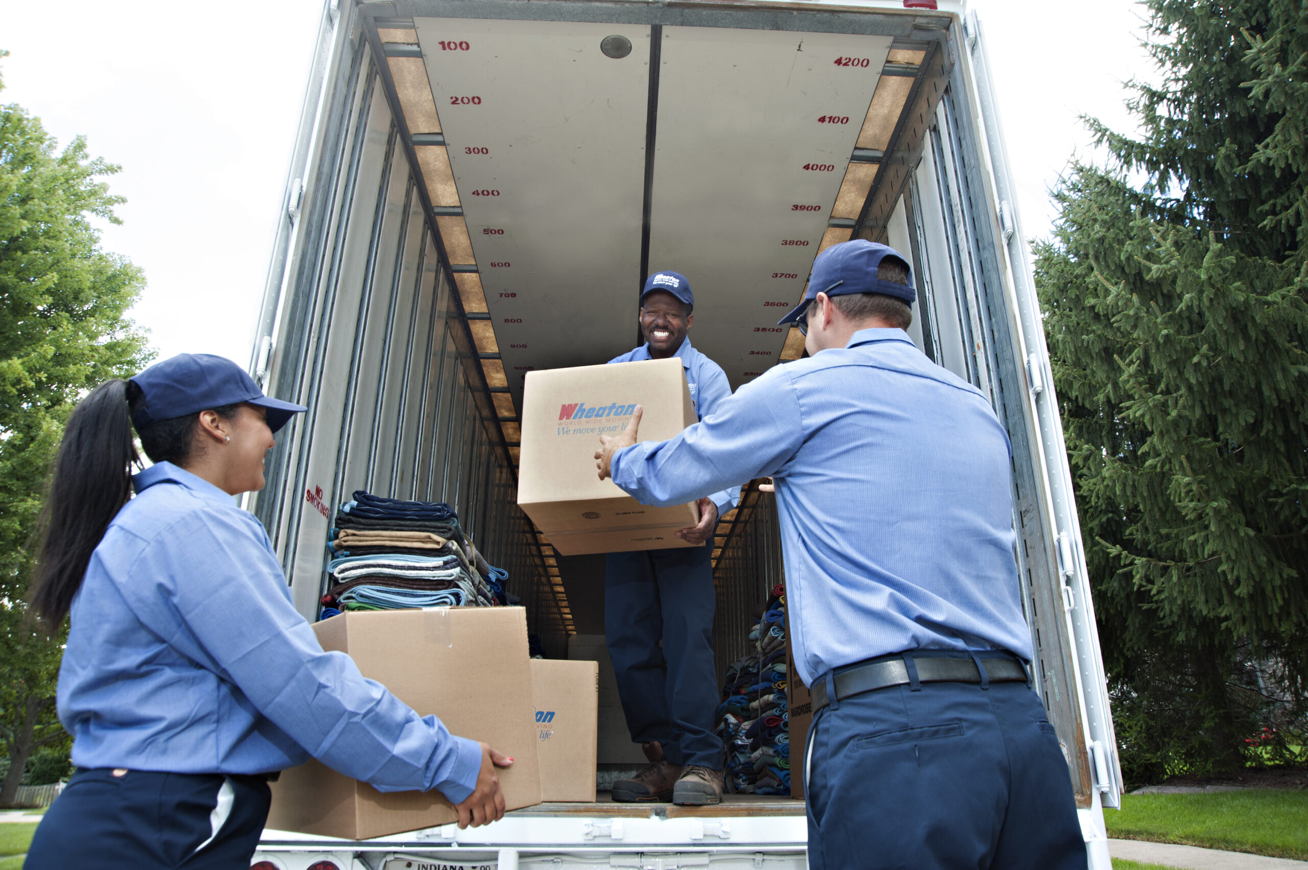 Wheaton World Wide Moving driver unloading a moving truck